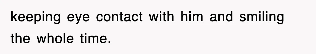 keeping eye contact with him and smiling the whole time.
