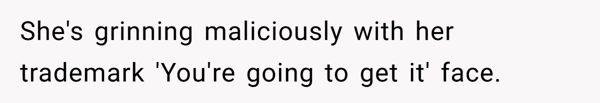 She's grinning maliciously with her trademark 'You're going to get it' face.