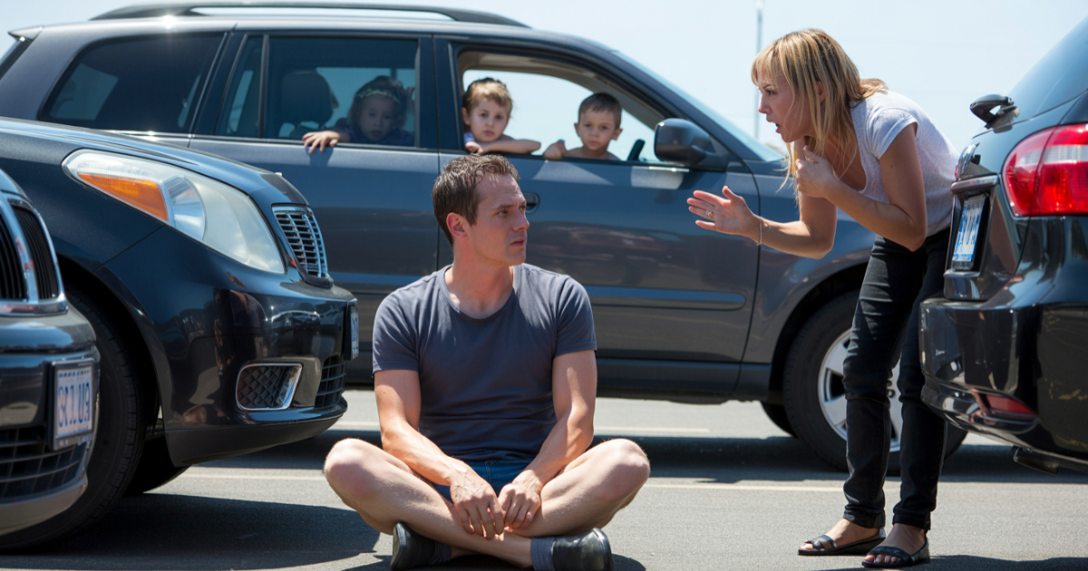 Woman Stood In A Parking Space To Save It, So Man Sits Down And Refuses To Move