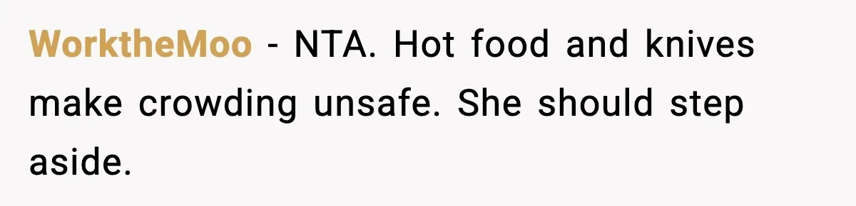 WorktheMoo - NTA. Hot food and knives make crowding unsafe. She should step aside.