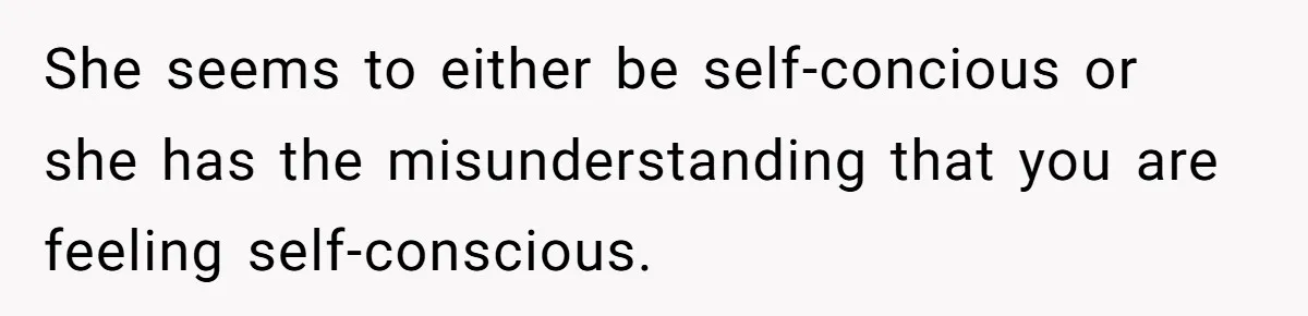 She seems to either be self-concious or she has the misunderstanding that you are feeling self-conscious.