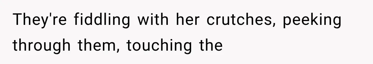 They're fiddling with her crutches, peeking through them, touching the
